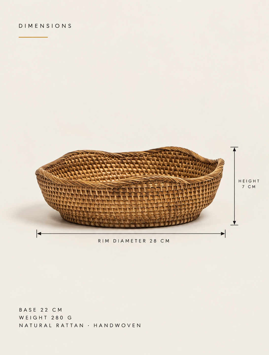 A shallow round bowl in undyed rattan, woven as one spiral from the centre out.